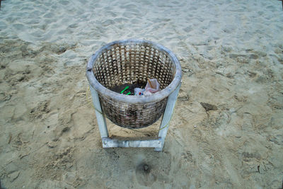 High angle view of wicker basket on beach