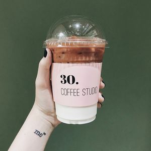 Close-up of hand holding coffee cup