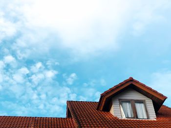 Low angle view of building against cloudy sky