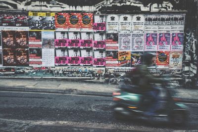 People riding motorcycle on road in city