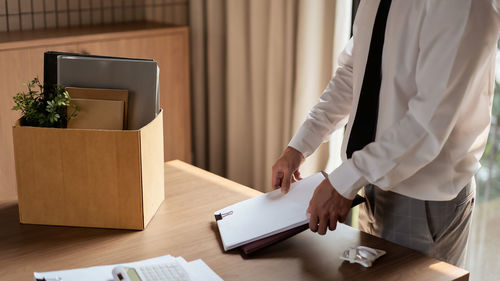 Midsection of man using laptop