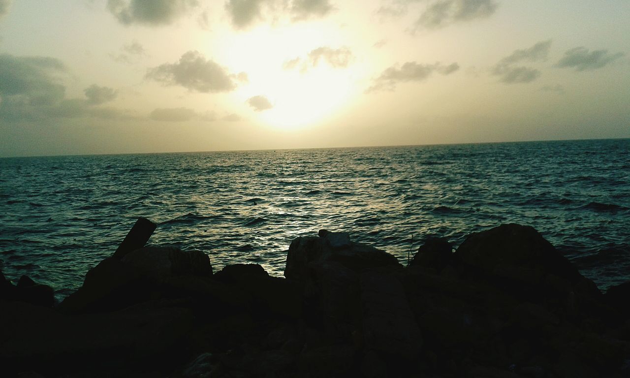 sea, horizon over water, water, tranquil scene, scenics, tranquility, sky, beauty in nature, sunset, nature, rock - object, silhouette, idyllic, rock formation, cloud - sky, seascape, cloud, beach, rippled, remote