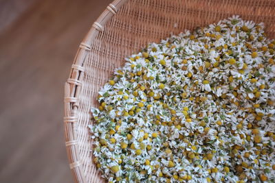 High angle view of chamomiles in wicker bowl