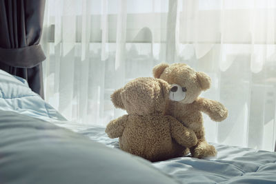 Stuffed toys on bed at home