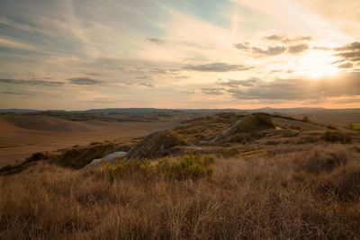 Scenic view of landscape against sky during sunset