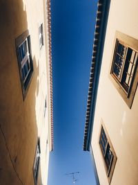 Low angle view of buildings against clear blue sky
