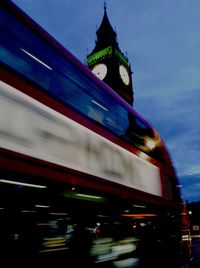 Low angle view of clock tower at night