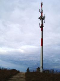 Low angle view of communications tower against sky