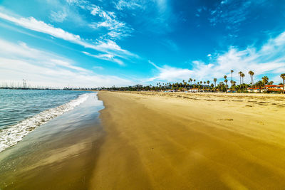 Scenic view of beach against blue sky