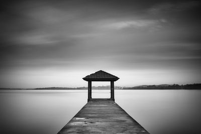 Pier over lake against sky