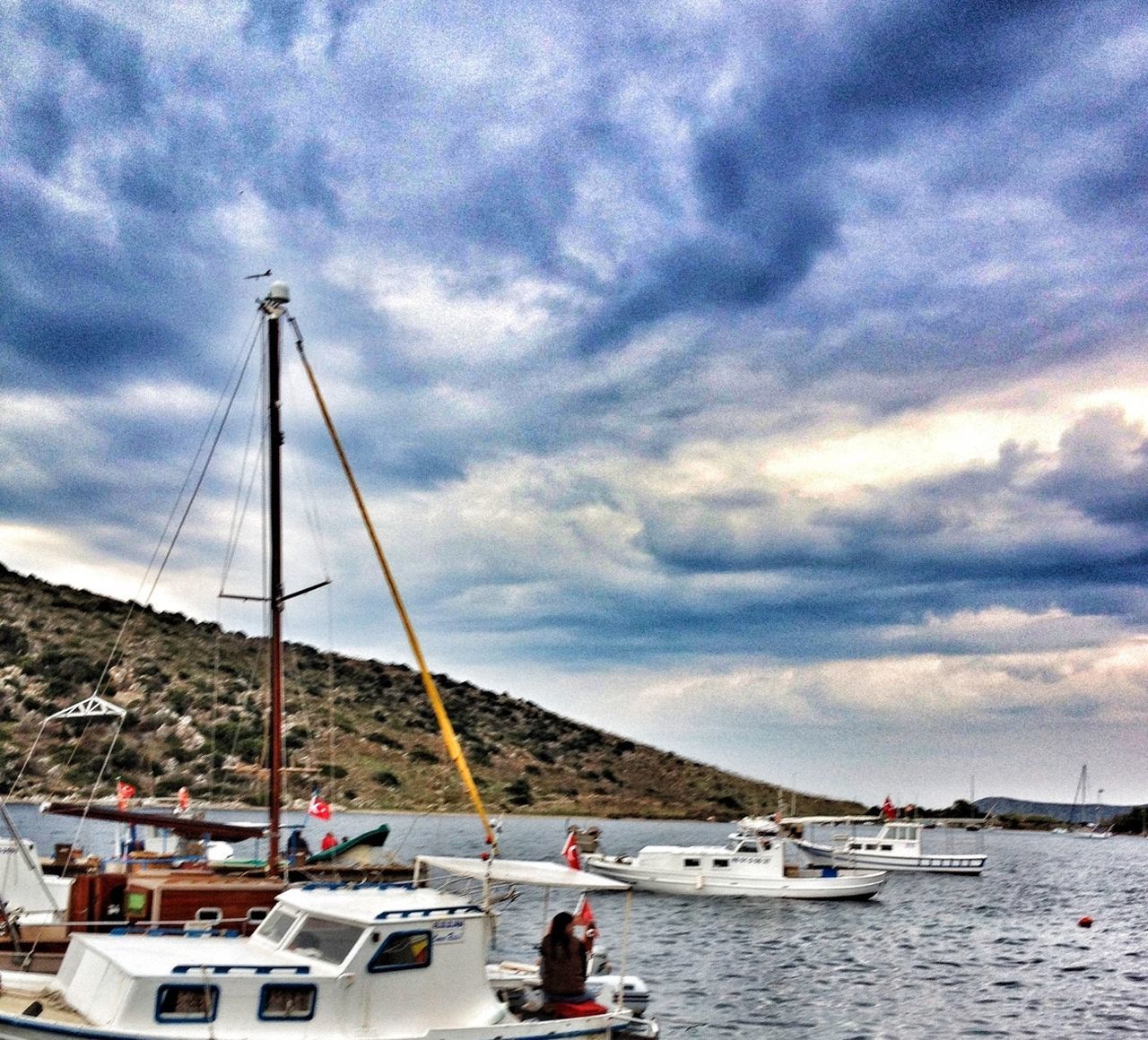 sky, water, sea, cloud - sky, nautical vessel, cloudy, mountain, scenics, boat, cloud, transportation, leisure activity, beauty in nature, lifestyles, nature, vacations, tranquility, tranquil scene, travel