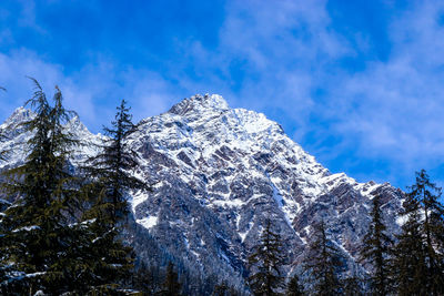 Low angle view of snowcapped mountain against sky