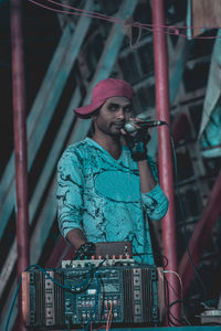 Man holding microphone during event at night