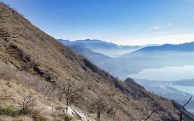 Scenic view of mountains against blue sky