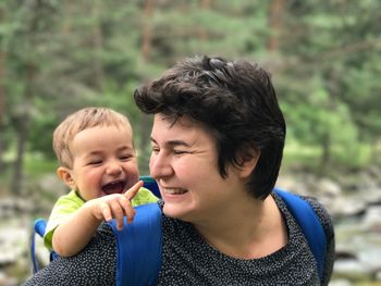 Close-up of smiling woman with baby boy