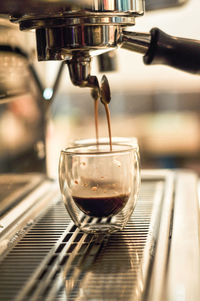 Close-up of coffee pouring in cafe