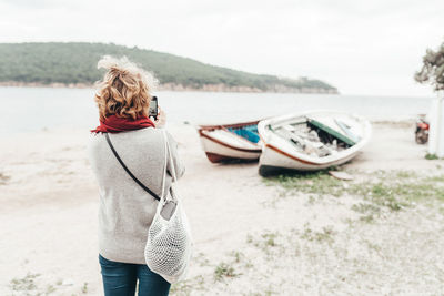 Rear view of woman standing on beach