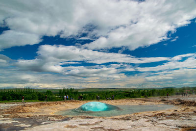 Scenic view of land against cloudy sky