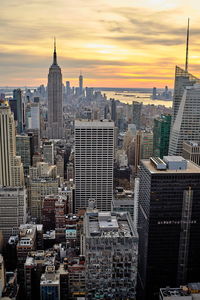 Aerial view of buildings in city during sunset