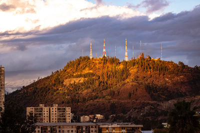 Panoramic view of buildings and mountains against sky