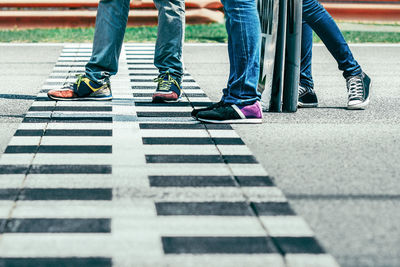 Low section of people walking on road