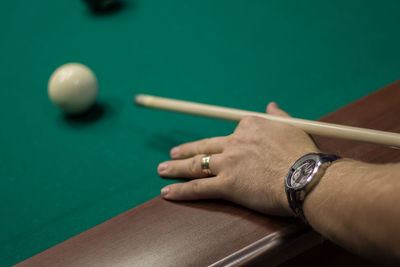 Close-up of hand playing snooker