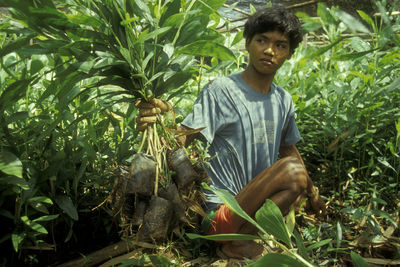 Portrait of young man standing on land