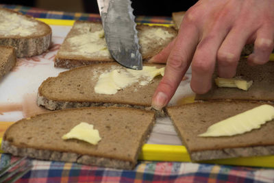 Close-up of person preparing food on table