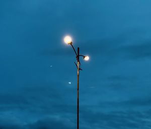 Low angle view of street light against blue sky