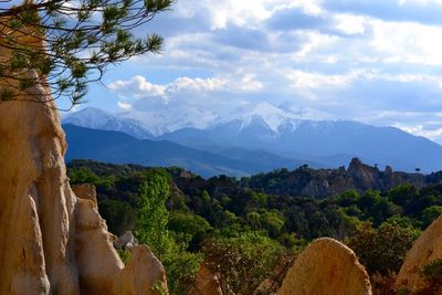 Scenic view of mountains against cloudy sky