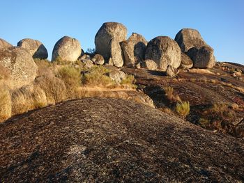 Rocks on land against clear sky