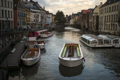 Boats in canal with buildings in background
