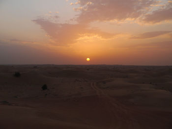 Scenic view of beach against sky during sunset