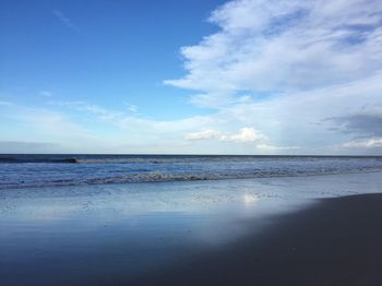 Scenic view of sea against cloudy sky