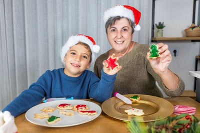 Portrait of smiling young woman having food at home