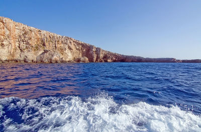 Scenic view of sea against clear blue sky