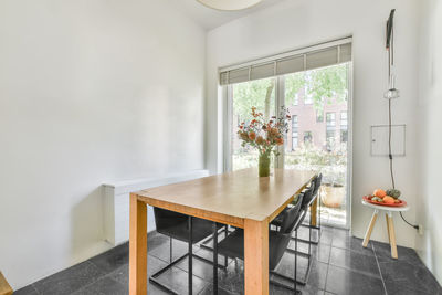 Potted plant on table by window at home