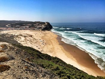 Scenic view of beach against clear sky