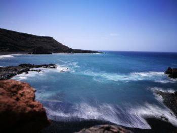 Scenic view of sea against clear blue sky