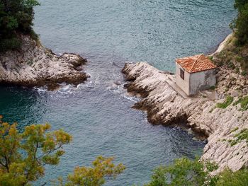 High angle view of rocks by sea