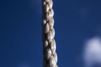 Low angle view of rope against blue sky