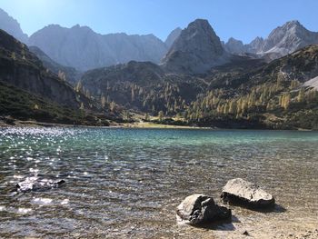 Scenic view of lake and mountains against sky