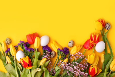 Close-up of christmas decorations against yellow background