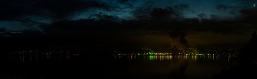 Scenic view of lake against sky at night