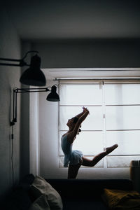 Young ballerina dancing at home