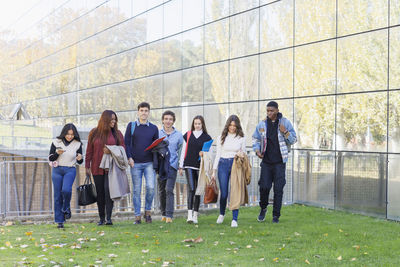 Multiracial students walking on university campus