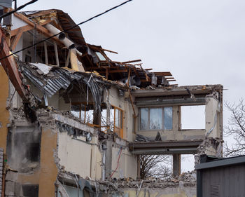 Low angle view of abandoned building against sky