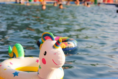 A swimming circle in the form of a unicorn is floating in the pool. concept of summer holidays. 