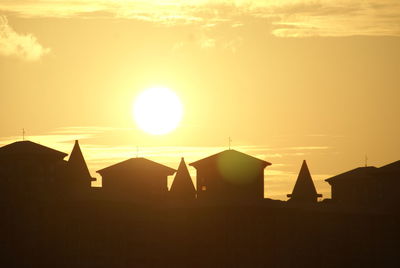 Silhouette of built structure at sunset