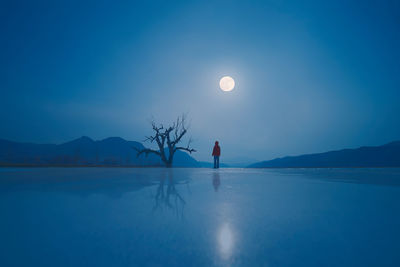 Scenic view of frozen lake against blue sky at night